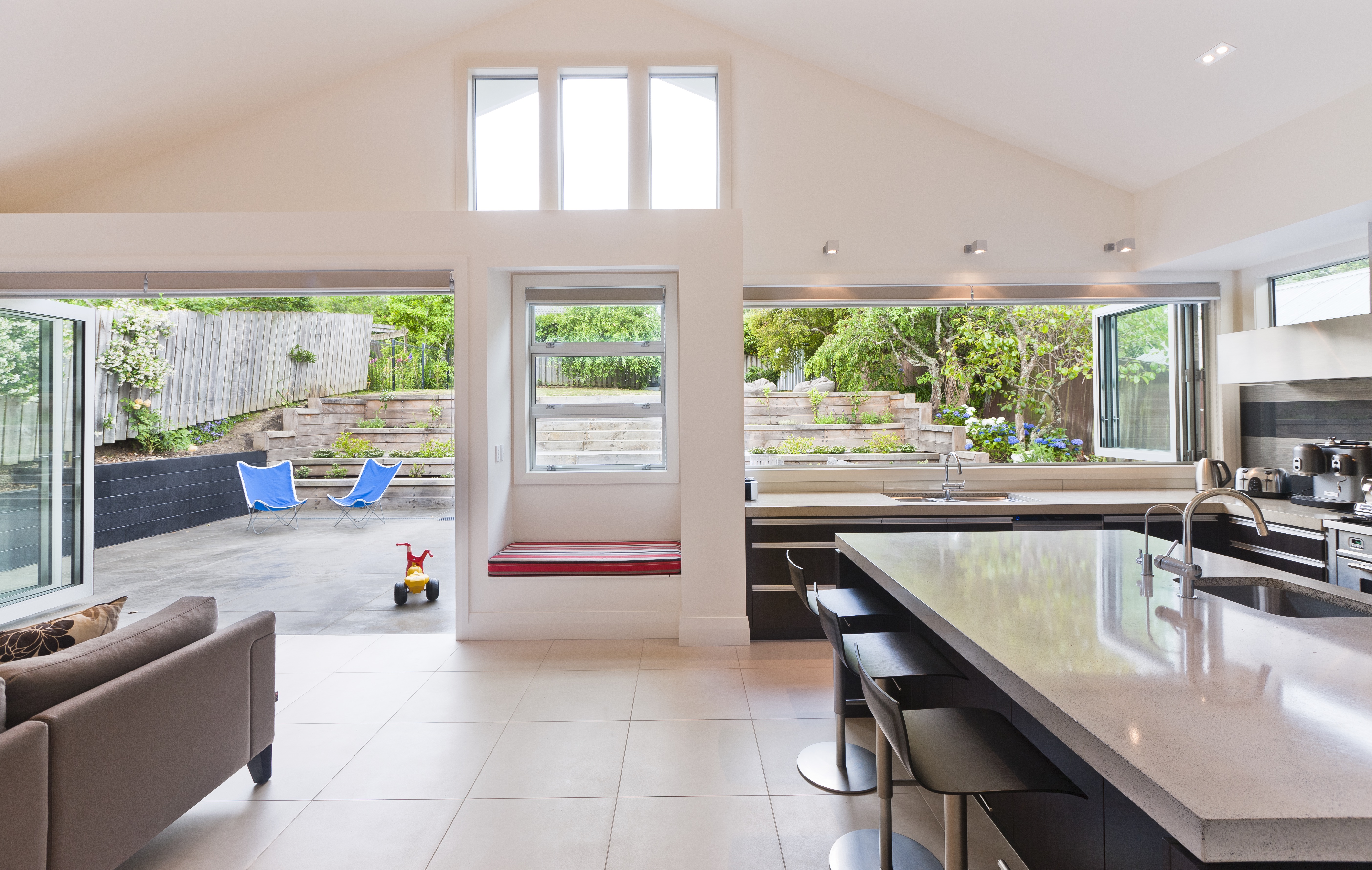 In this villa extension, the exterior wall was deepened to accommodate a simple built-in seat and the adjacent kitchen benchtop.